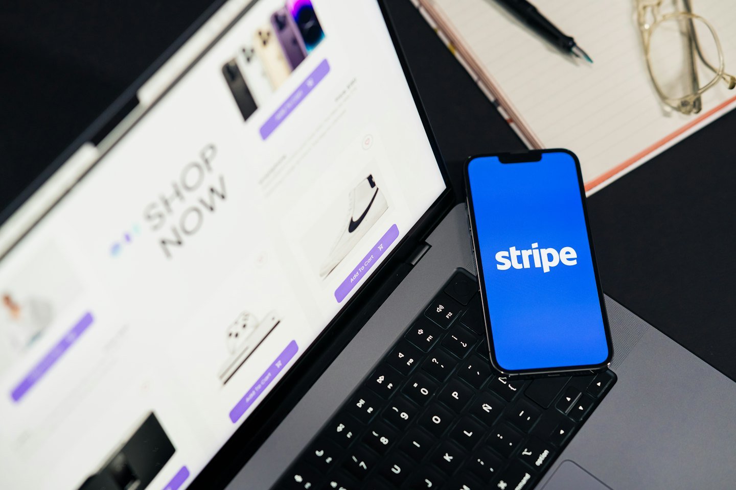 Laptop and smartphone displaying online shopping and payment interfaces.